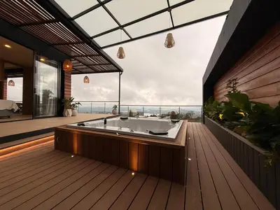 a bath tub on a deck with a view of the ocean at Montecielo Lodge 11 El peñol - Guatape in Chiquinquirá