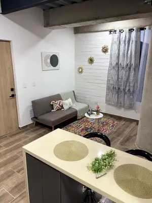 a living room with a couch and a table at Industrial Loft near Poblado, Medellín in Medellín