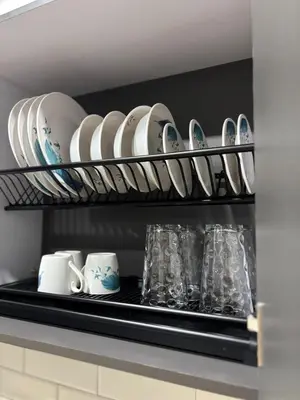 a shelf with plates and cups on it in a kitchen at Industrial Loft near Poblado, Medellín in Medellín