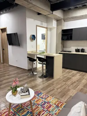an open kitchen with a table and a counter at Industrial Loft near Poblado, Medellín in Medellín