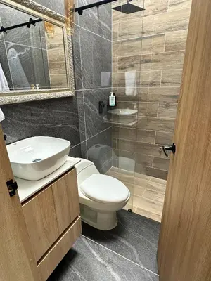 a bathroom with a toilet and a sink and a mirror at Casa Bosques La Ceja in La Ceja