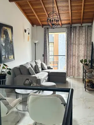 a living room with a couch and a table at Casa Bosques La Ceja in La Ceja