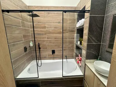 a bathroom with a tub and a sink at Casa Bosques La Ceja in La Ceja