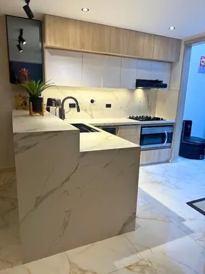 a kitchen with marble counter tops and a sink at Casa Bosques La Ceja in La Ceja