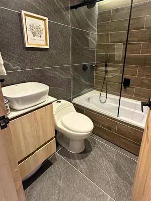 a bathroom with a toilet and a sink and a tub at Casa Bosques La Ceja in La Ceja