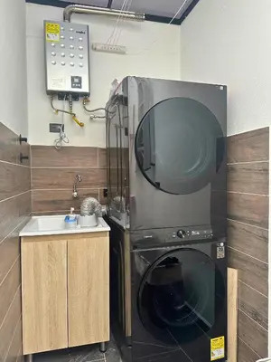 a kitchen with a washing machine and a sink at Casa Bosques La Ceja in La Ceja