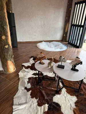 a room with two tables with toy animals on them at Entre pinos in Chiquinquirá