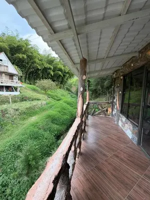 a porch of a house with a wooden deck at Entre pinos in Chiquinquirá