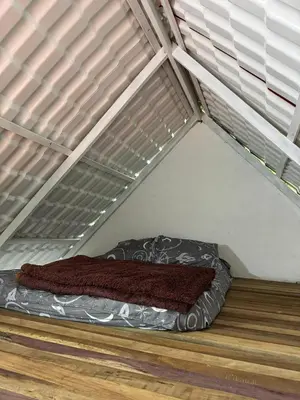 a small bed in a room with atainedigunigunigunigun at Entre pinos in Chiquinquirá