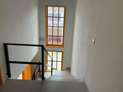 a staircase in a white room with a window at Jerico Poets Balcony House in Jericó