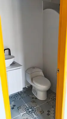 a bathroom with a white toilet and a sink at Jerico Poets Balcony House in Jericó