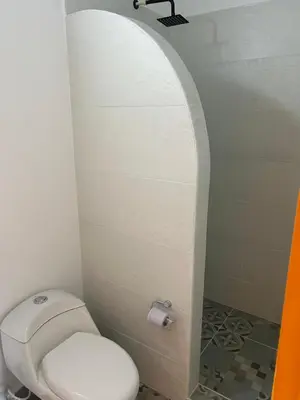a bathroom with a white toilet in a room at Jerico Poets Balcony House in Jericó