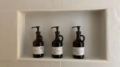 three bottles of wine sitting on a shelf at Jerico Poets Balcony House in Jericó