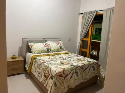 a bedroom with a bed and a window at Jerico Poets Balcony House in Jericó