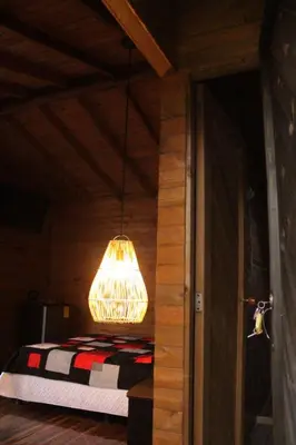 a chandelier hanging over a bed in a room at Cabañas con vista al Embalse in La Pradera