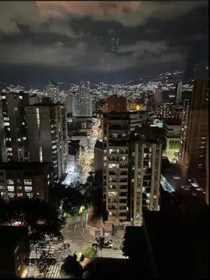 a view of a city at night with buildings at Urban Loft in the center in Medellín