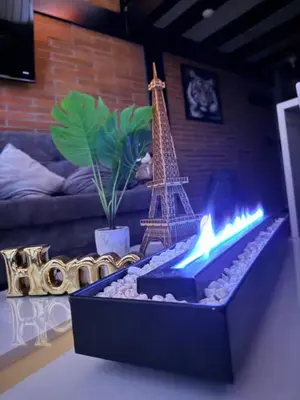 a fireplace in a living room with the eiffel tower at Urban Loft in the center in Medellín