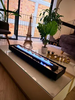 a fire pit in a living room with the eiffel tower at Urban Loft in the center in Medellín