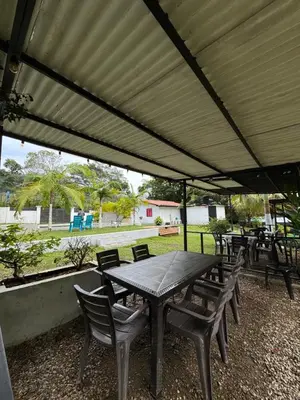 a group of tables and chairs under a canopy at Vía las palmas in Victoria