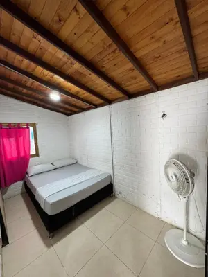 a small room with a bed and a fan at Vía las palmas in Victoria