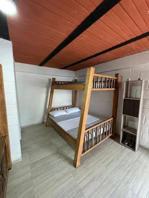 two bunk beds in a room with a wooden ceiling at Vía las palmas in Victoria