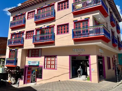 a large building with red and blue balconies on it at Apto full Ubicación Plazoleta Zocalos Plaza Ppal in Guatapé