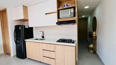 a kitchen with a black refrigerator and a microwave at Apto full Ubicación Plazoleta Zocalos Plaza Ppal in Guatapé