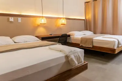 a room with two beds and a desk with two beds at The Living Hub in La Dorada