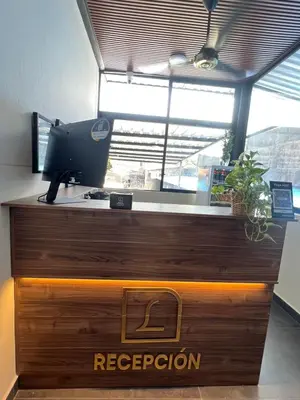 a reception desk with a computer on top of it at The Living Hub in La Dorada