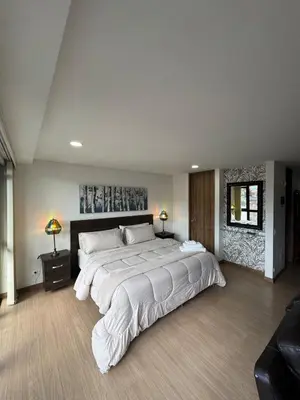a large bedroom with a large white bed in it at Reposso Laureles in Medellín