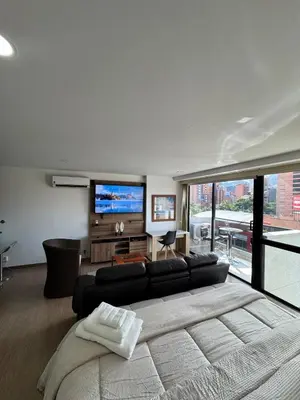 a living room with a couch and a flat screen tv at Reposso Laureles in Medellín