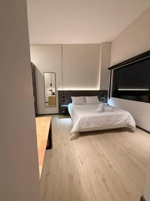 a bedroom with a white bed and a large window at Estrena Apartamento, Avenida Santander, Edificio BREAK in Manizales