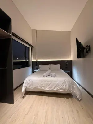 a bedroom with a bed and a large window at Estrena Apartamento, Avenida Santander, Edificio BREAK in Manizales