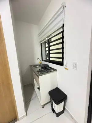 a small kitchen with a stove and a window at Casa Bendita - Apto 101 in Medellín