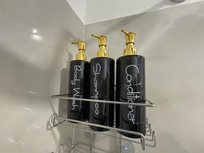 two black and gold injector bottles on a shelf at Casa Bendita - Apto 101 in Medellín