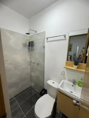 a bathroom with a shower and a toilet and a sink at Casa Bendita - Apto 101 in Medellín