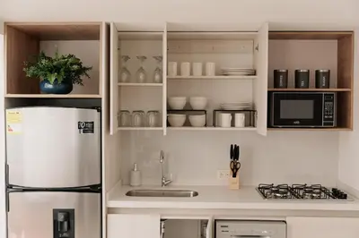 a kitchen with a refrigerator and a microwave at Casa G, en Rionegro in Rionegro