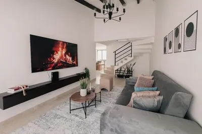 a living room with a couch and a fireplace at Casa G, en Rionegro in Rionegro