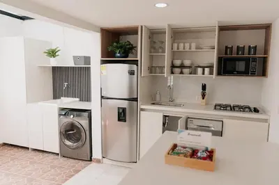 a kitchen with a refrigerator and a washer and dryer at Casa G, en Rionegro in Rionegro