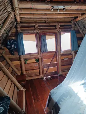 an inside view of a room with windows and a bed at Cabanas ecologicas con vista espectacular y cascada privada - Finca Qawana Ecolodge en San Carlos