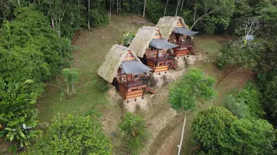 an overhead view of a group of houses with grass roofs at Cabanas ecologicas con vista espectacular y cascada privada - Finca Qawana Ecolodge en San Carlos
