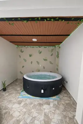 a hot tub in a room with a wooden ceiling at Maranatha Jacuzzi, Rooftop BBQ, Sopetran Antioquia in Sopetran