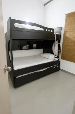 a small room with a black bunk bed at Maranatha Jacuzzi, Rooftop BBQ, Sopetran Antioquia in Sopetran