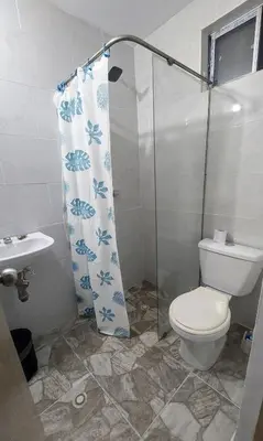 a bathroom with a toilet and a shower curtain at Maranatha Jacuzzi, Rooftop BBQ, Sopetran Antioquia in Sopetran