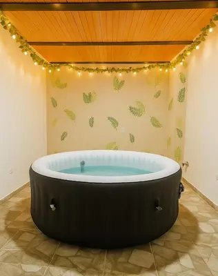 a bath tub in a room with lights at Maranatha Jacuzzi, Rooftop BBQ, Sopetran Antioquia in Sopetran
