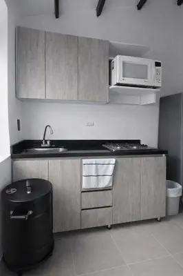 a kitchen with a sink and a microwave at Maranatha Jacuzzi, Rooftop BBQ, Sopetran Antioquia in Sopetran