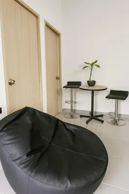 a black bean bag chair in a room with a table at Maranatha Jacuzzi, Rooftop BBQ, Sopetran Antioquia in Sopetran