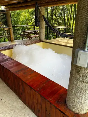 a pile of snow sitting next to a tree at Vip cabaña vista verde in Cocorná