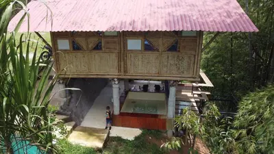 a person standing in front of a house at Vip cabaña vista verde in Cocorná
