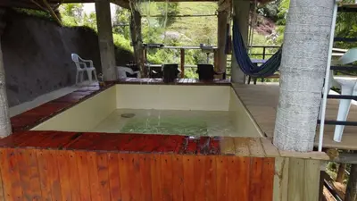 a bath tub with water in the middle of a patio at Vip cabaña vista verde in Cocorná